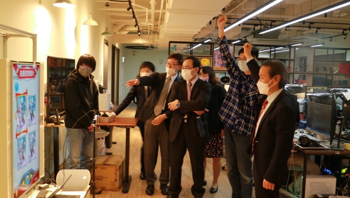 112年3月27日日本九州工業大學校長三谷康範（右一）參訪臺科大數位發展研究中心，與中心研究生共同進行遊戲互動。
